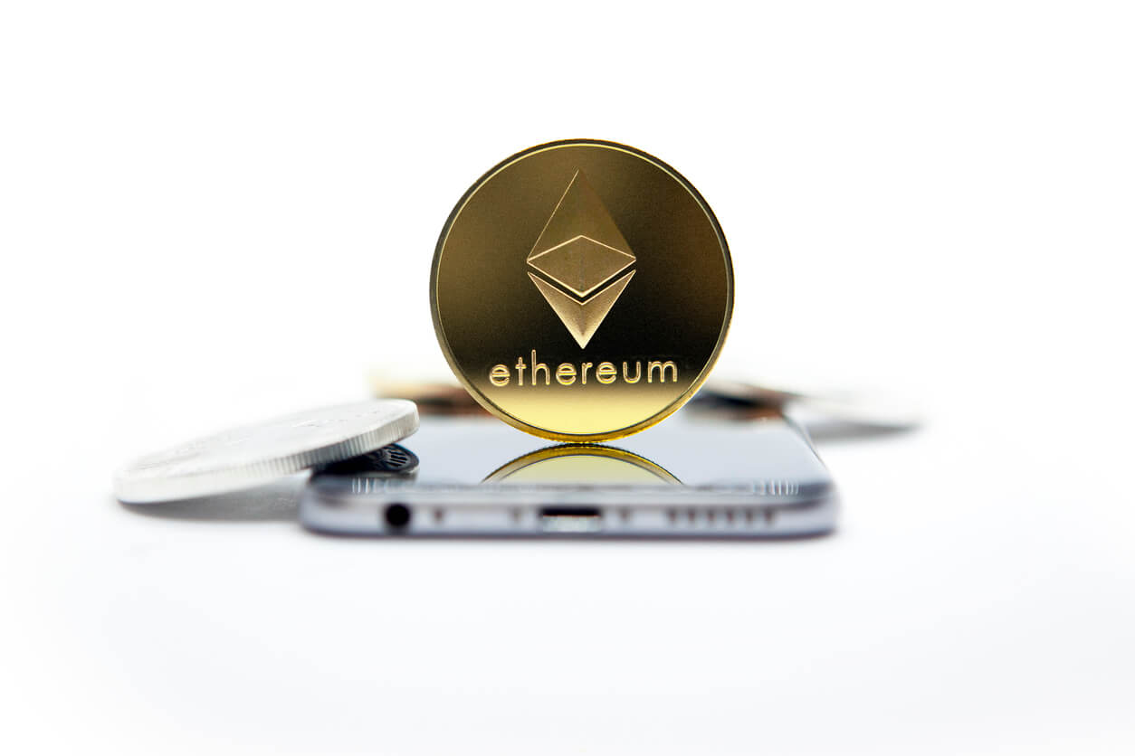 Etherum coin sitting on-top of a smartphone