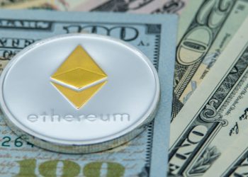 ethereum coin sitting on top notes