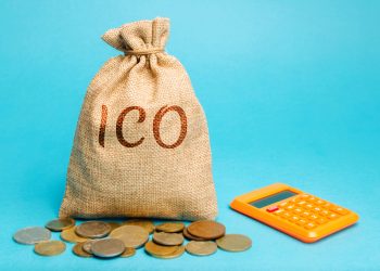 Money bag with the word ICO ( Initial coin offering ) and calculator. Attracting investments in the form of selling to investors a fixed number of new units of cryptocurrencies
