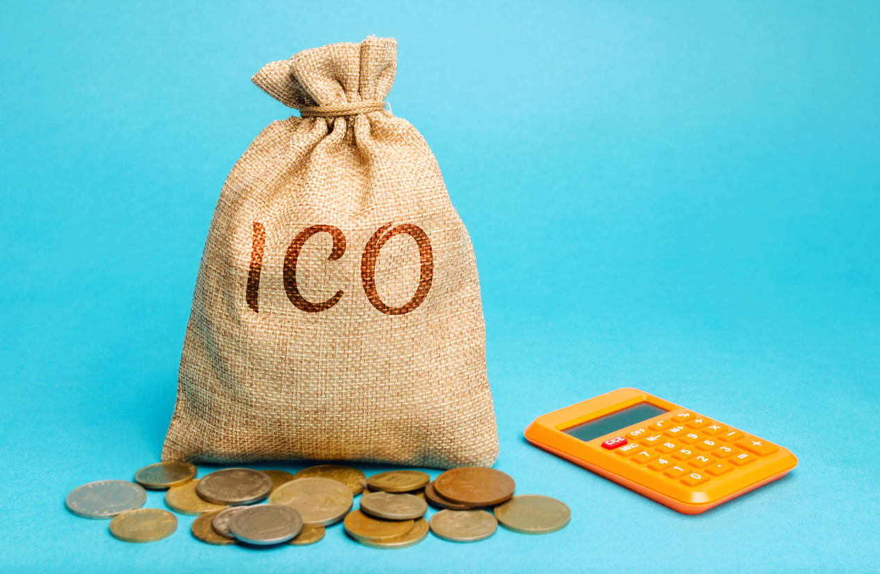 Money bag with the word ICO ( Initial coin offering ) and calculator. Attracting investments in the form of selling to investors a fixed number of new units of cryptocurrencies