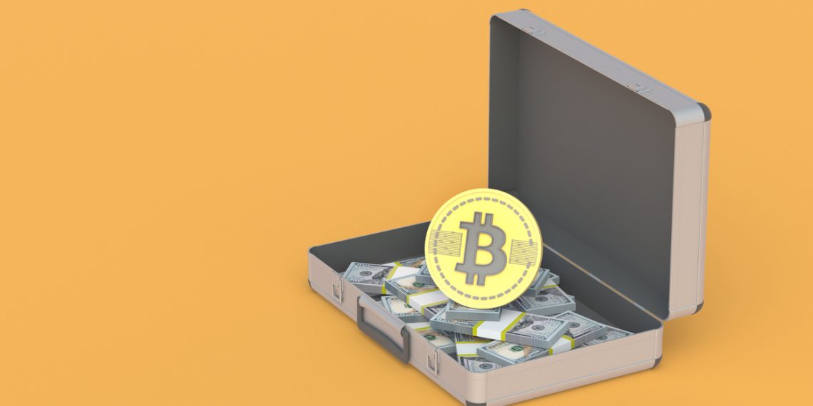 An open suitcase with money next to a bitcoin coin. Exchange, cashing of virtual currency. Investing, reinvesting in mining and cryptocurrency.