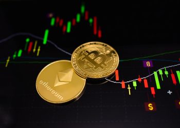 Physical bitcoin and ethereum coins on a chart background