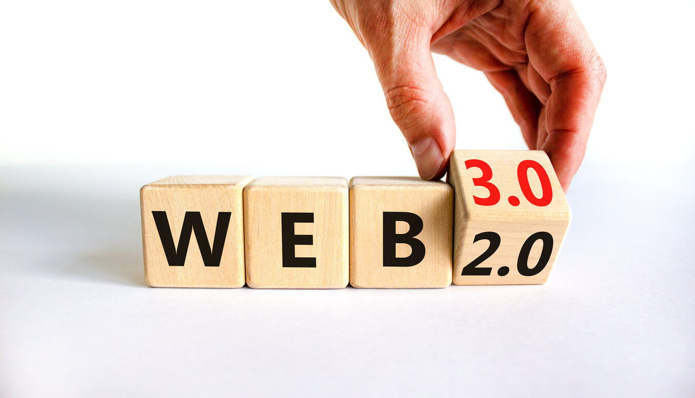 WEB 2.0 or 3.0 symbol. Businessman turns a wooden cube and changes words WEB 2.0 to WEB 3.0.