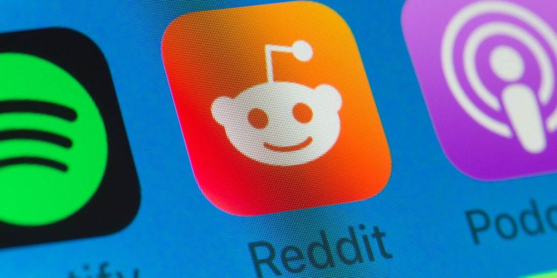 Reddit, Spotify, Podcasts and other cellphone Apps on iPhone screen