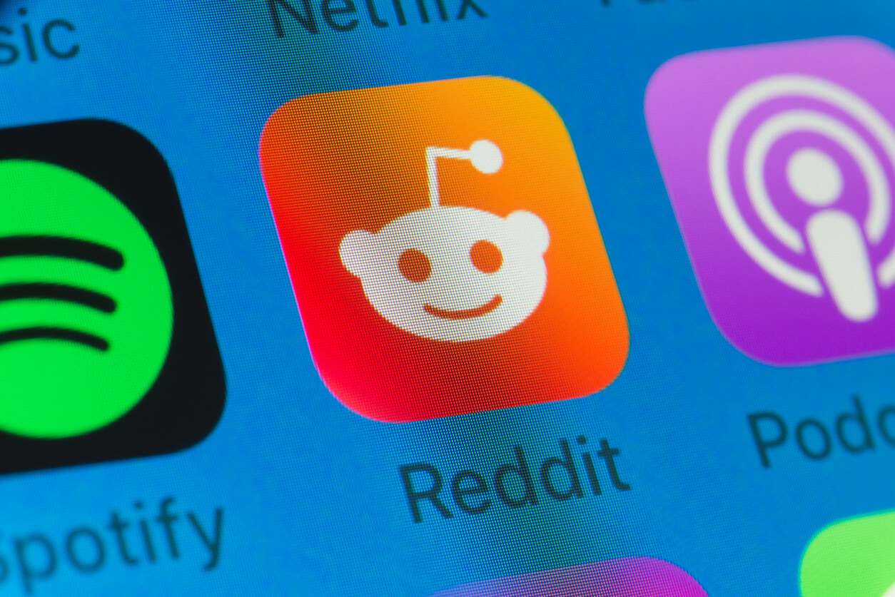 Reddit, Spotify, Podcasts and other cellphone Apps on iPhone screen