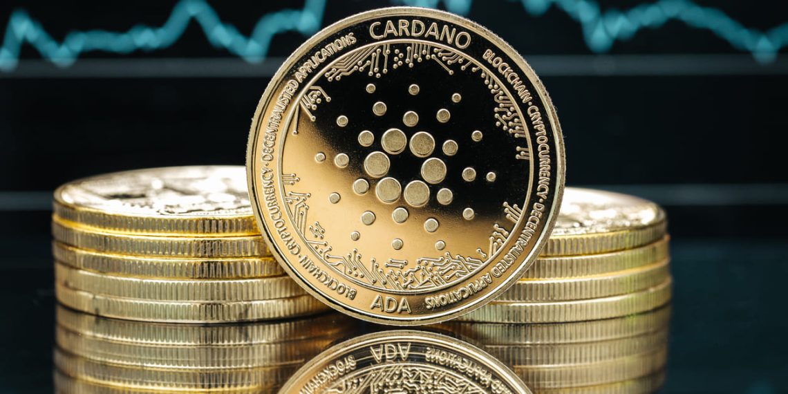 Cardano Ada cryptocurrency coin close-up, in front of a price chart stock photo..